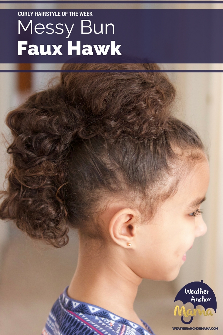 Toddler girl sporting a row of messy bun puffs in a faux hawk style