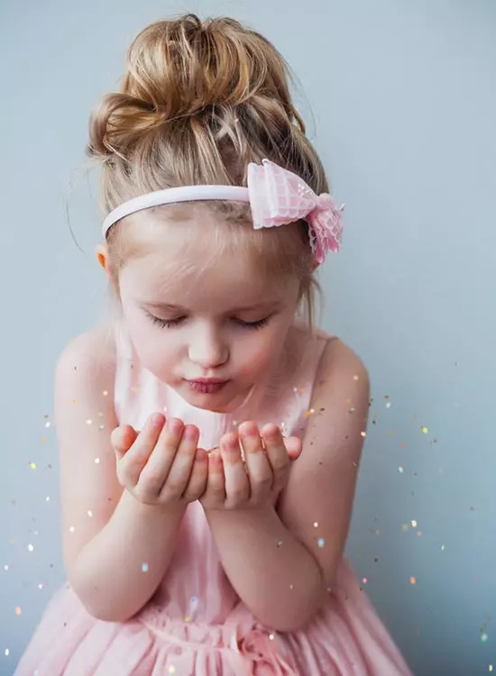 Toddler girl wearing a relaxed messy bun paired with a cute headband