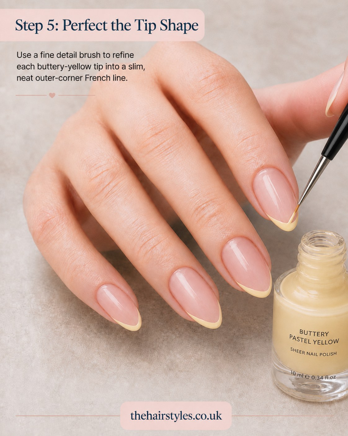 Refining the yellow tip line with a fine detail brush during blueberry French tip nails