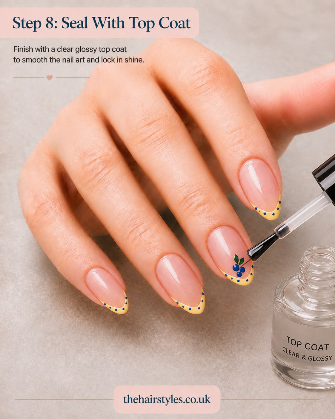 Sealing the finished blueberry French tip nails with a clear glossy top coat