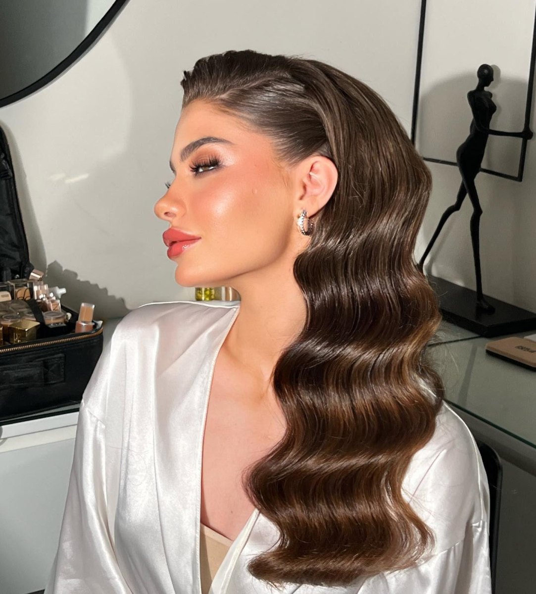 Shoulder length deep side part old hollywood waves