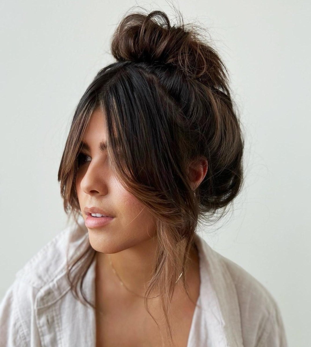 Loose bun with curtain fringe