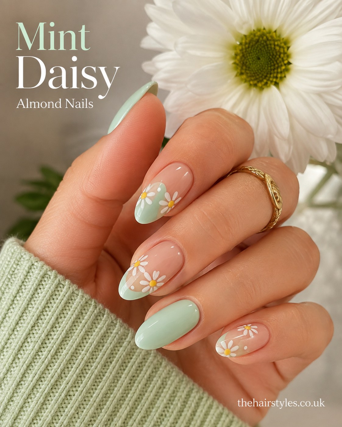 Mint green almond nails paired with hand-painted daisy flowers over a sheer pastel base