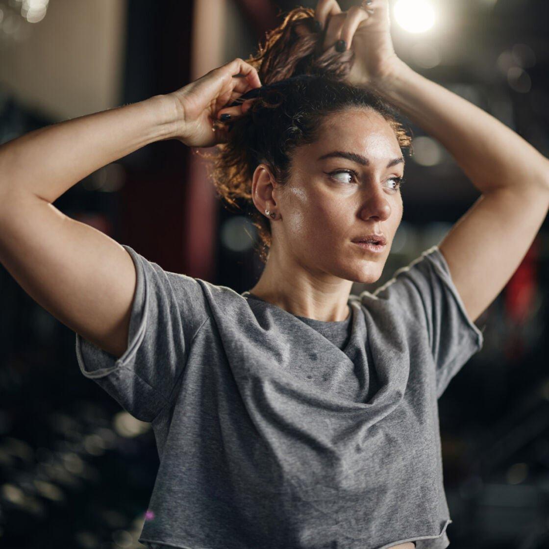 Woman preparing quick workout hairstyle