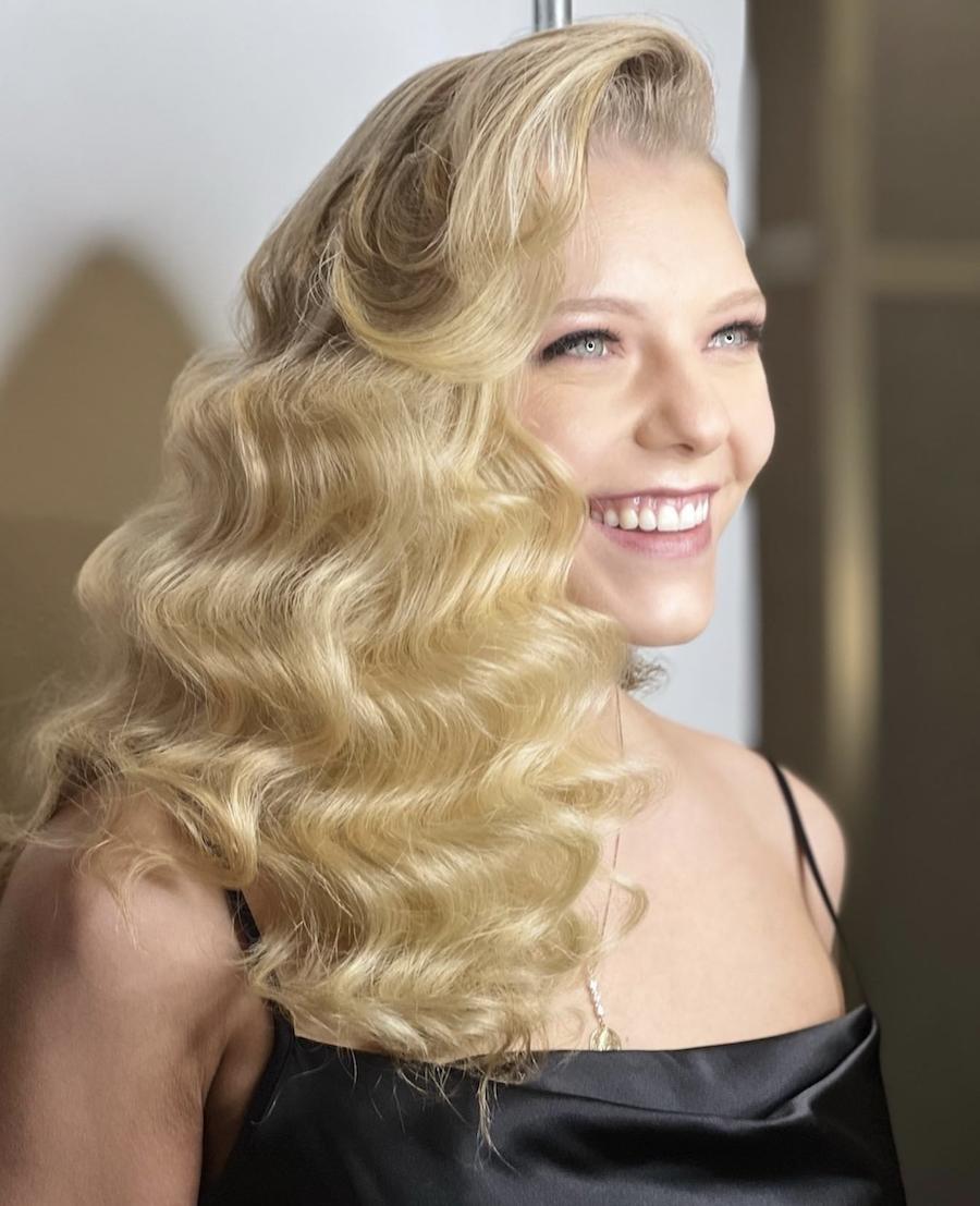 Soft blonde deep side part old hollywood waves hairstyle