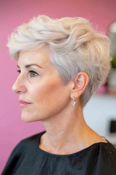 A stylish, short, wavy haircut with a voluminous top, ideal for wash-and-wear ease for women over 60.