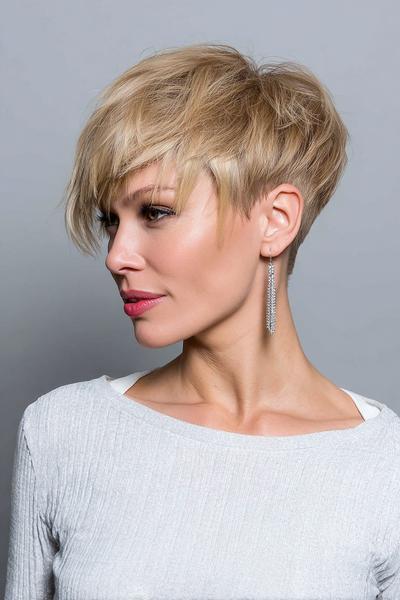 A woman with a textured blonde undercut pixie hairstyle, featuring longer layers on top and closely cropped sides, is shown in profile.